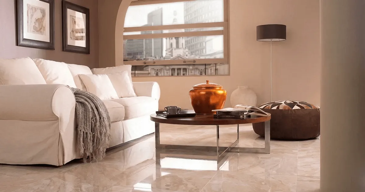 Modern living room with professionally installed marble flooring, a beige sofa, coffee table in Long Beach, CA